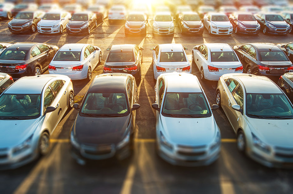 Several cars parked in the dealership parking lot